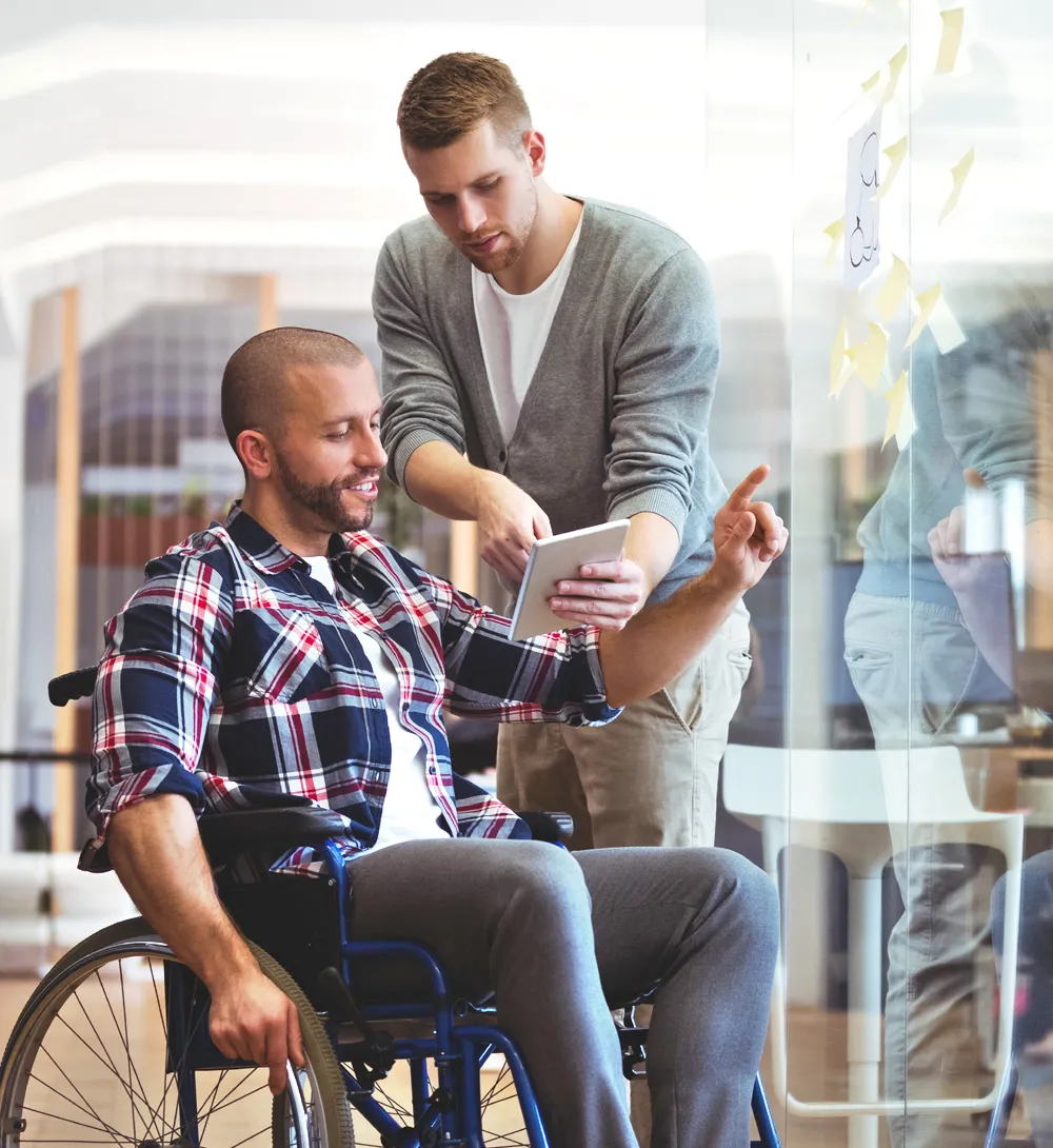 NDIS support worker guiding participant with resume writing for job hunting Gold Coast