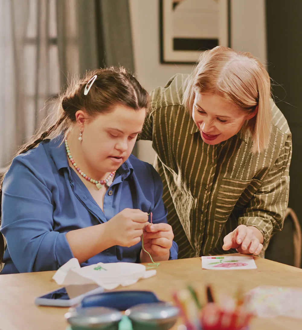 NDIS participant learning life skills with support worker in a shared living environment Gold Coast