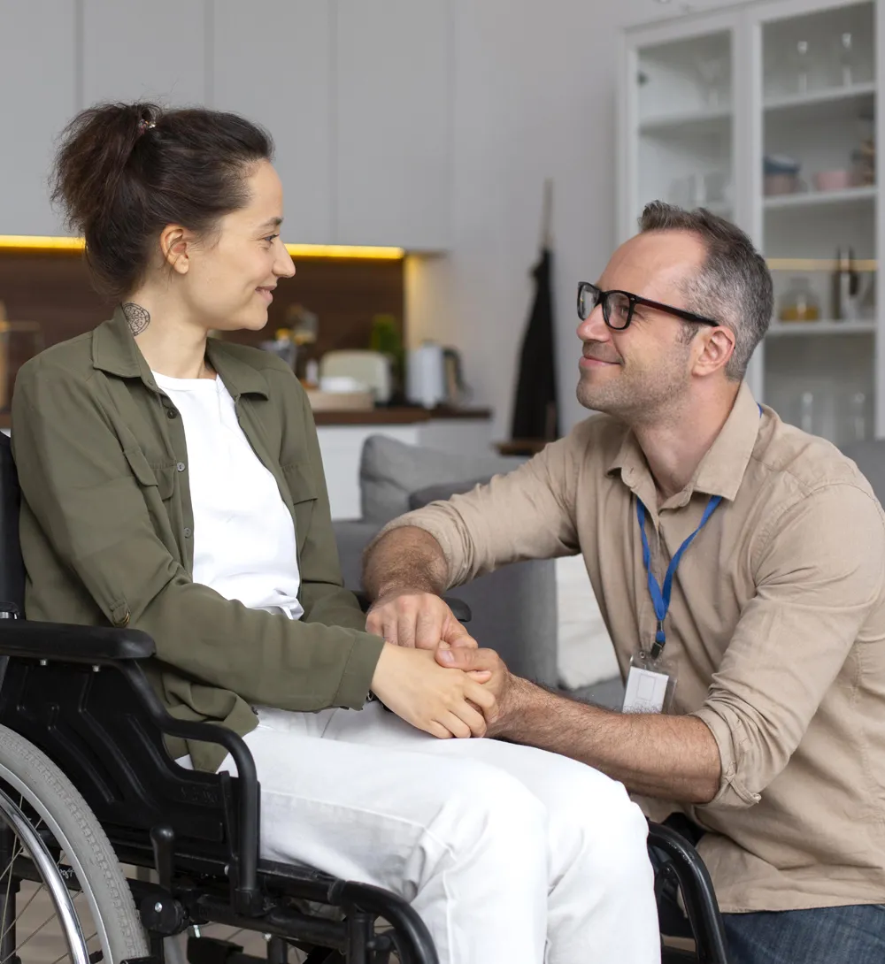 NDIS participants and support worker in a purpose-built SDA house discussing independent living Gold Coast